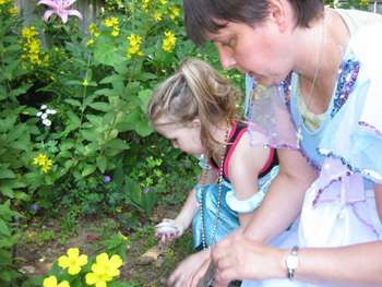 girl gardens with mom
